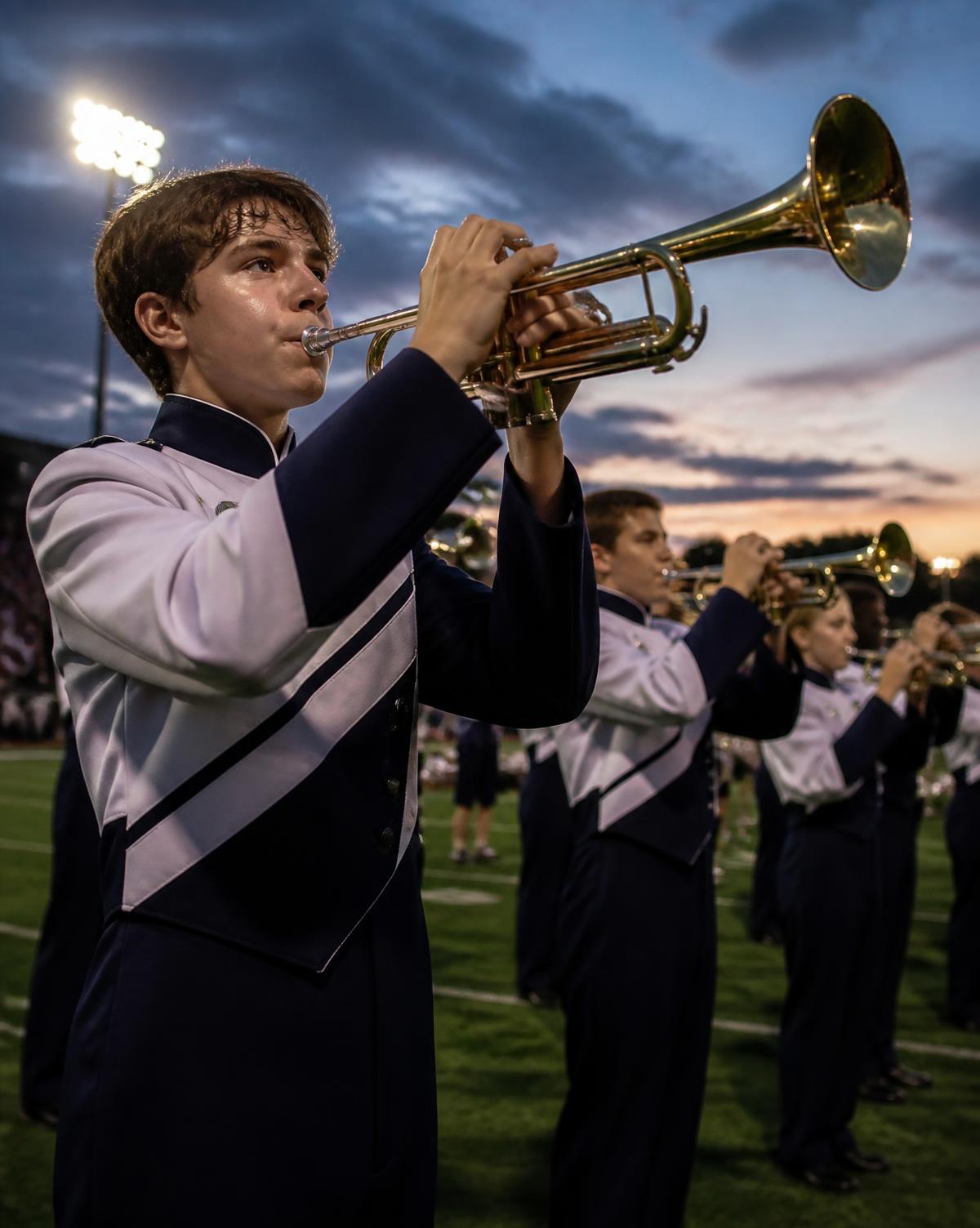 Marching band brass section performing on a field